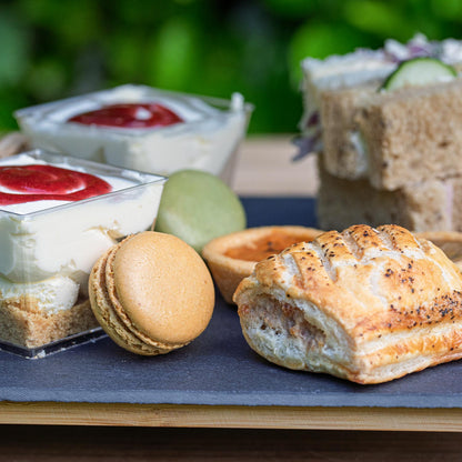 Barnsdale Afternoon Tea from The Helenium Tea Room at Barnsdale Gardens. Assorted pastries and desserts on a slate board
