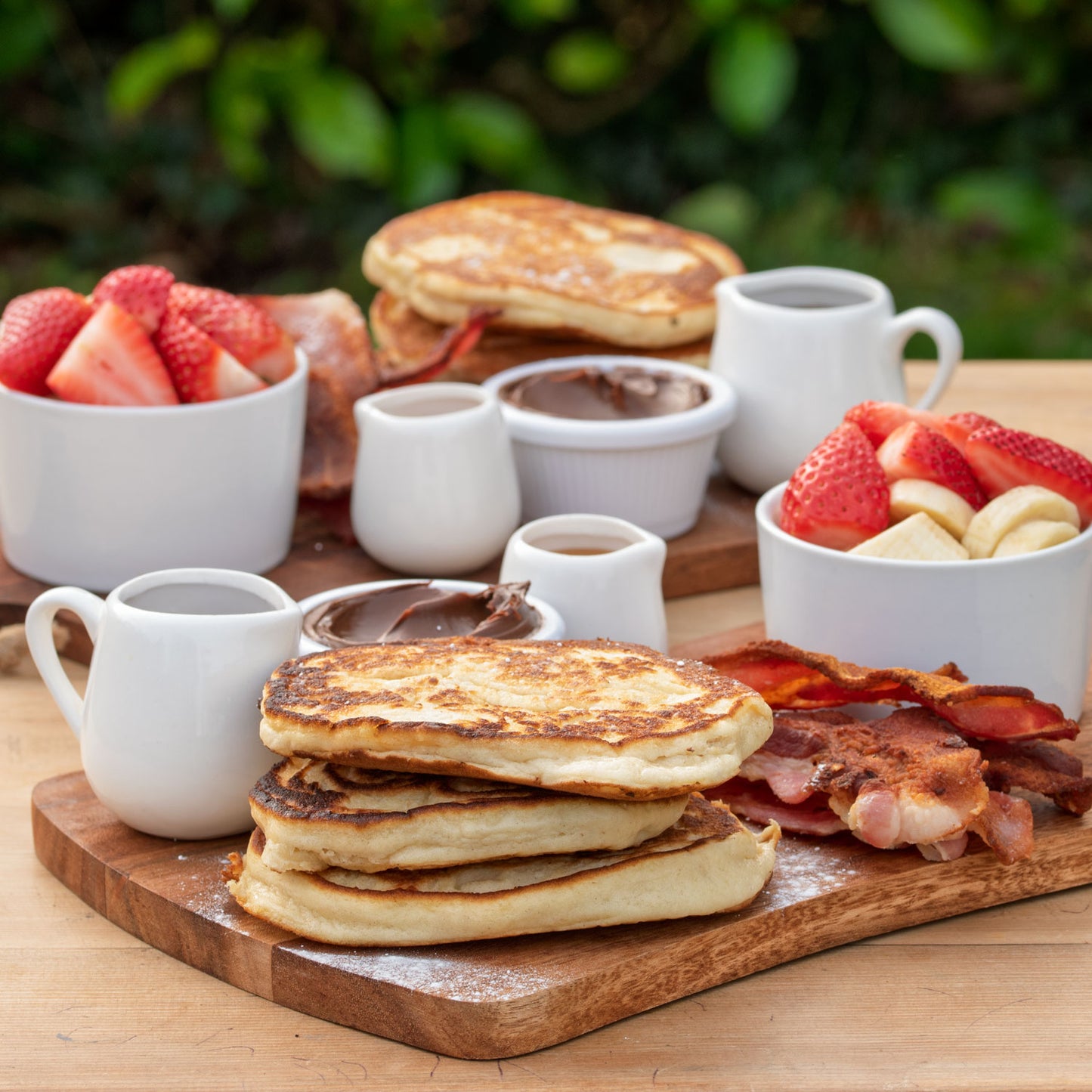 Pancake Sharing Board: American pancakes; Smoked streaky bacon; Fruit; Nutella; Honey; Maple sauce.